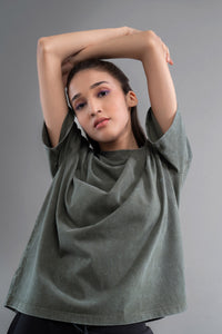 Green acid wash unisex t-shirt styled by a model.