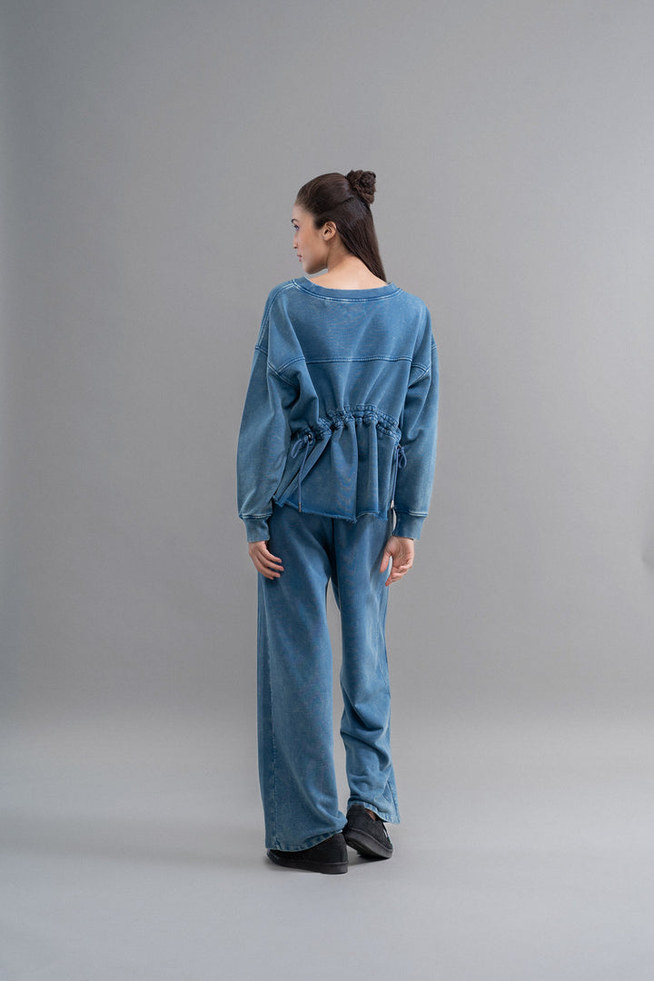 Denim wash cotton terry sweatshirt with ruched design in blue.