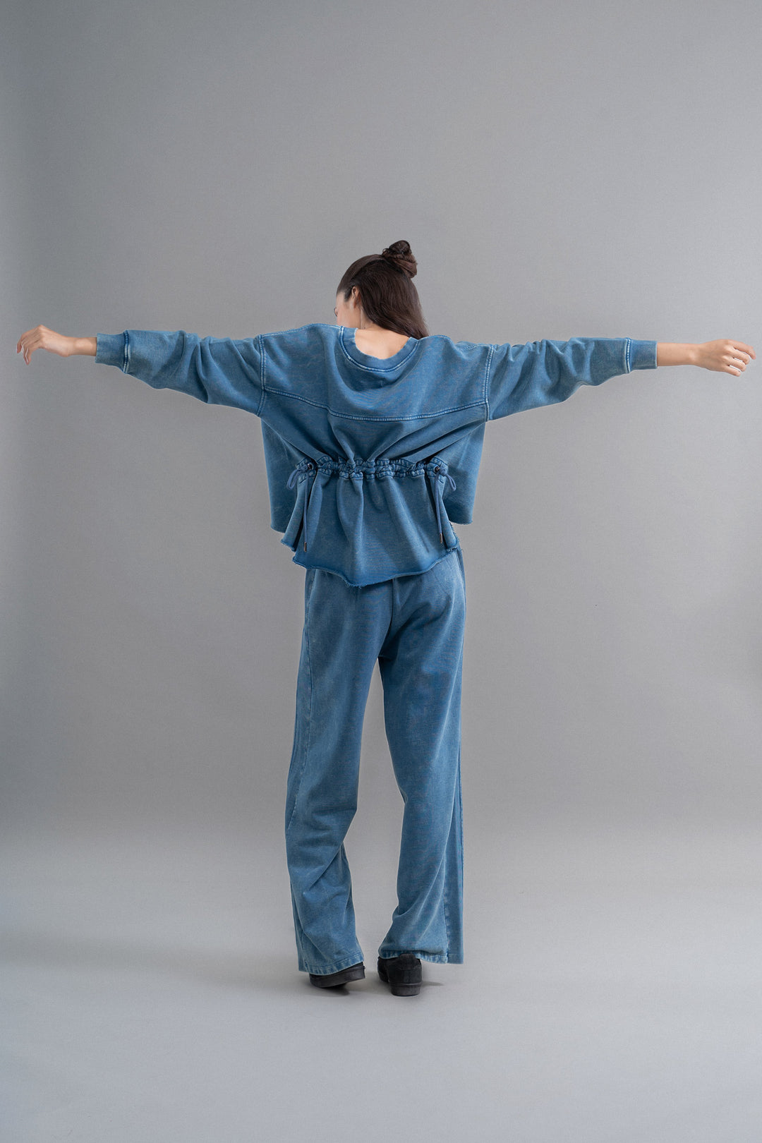 Denim wash cotton terry ruched sweatshirt for casual comfort.