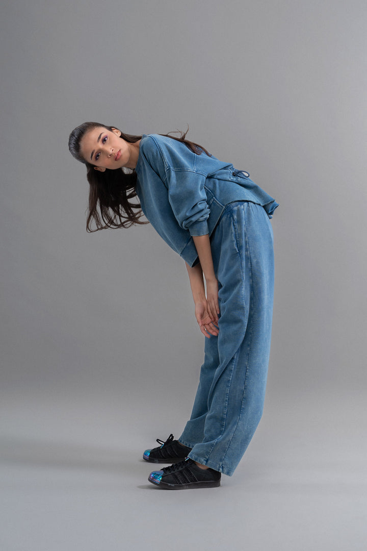 Model wearing denim wash 100% cotton terry ruched sweatshirt.