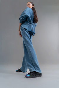 Model showcases Denim Wash 100% Cotton Terry Straight Travel Pant.