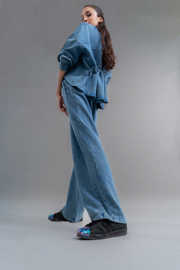 Model showcases Denim Wash 100% Cotton Terry Straight Travel Pant.