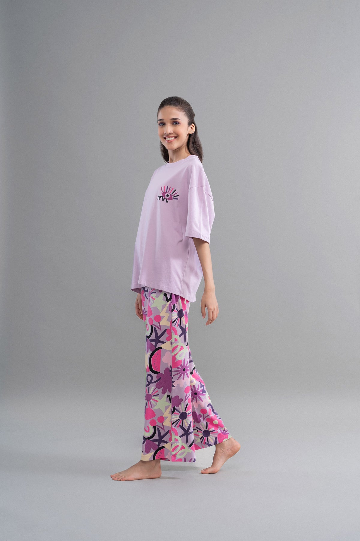 Enchanting purple flared pajamas with playful floral patterns for women.