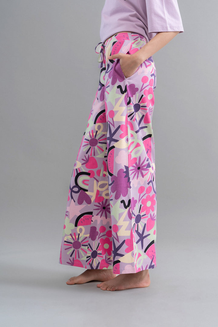 Enchanted Purple Cotton Pajama Set with colorful floral design and pockets.
