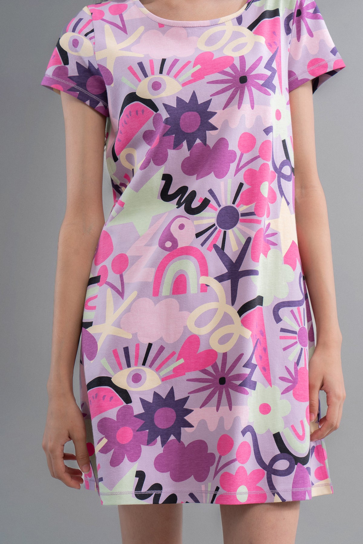 Enchanted purple cotton short dress with vibrant floral patterns.