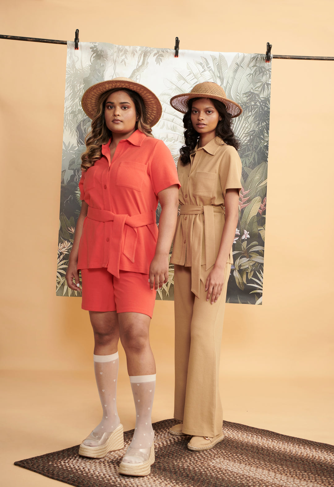 "Two models showcasing Mini Waffle Brown Flared Pants in stylish outfits."