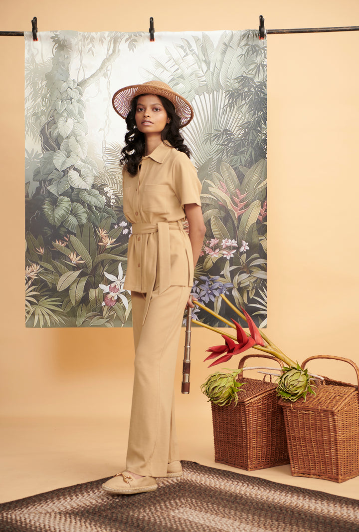 Model showcasing Mini Waffle Brown Safari outfit with tropical backdrop.
