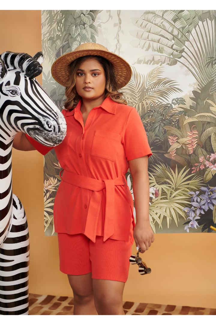 Model wearing Mini Waffle Red Safari Bermuda Set with zebra decoration.