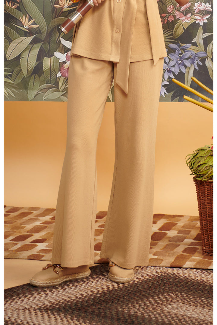 Mini waffle brown flared pants styled with a cozy top and shoes.
