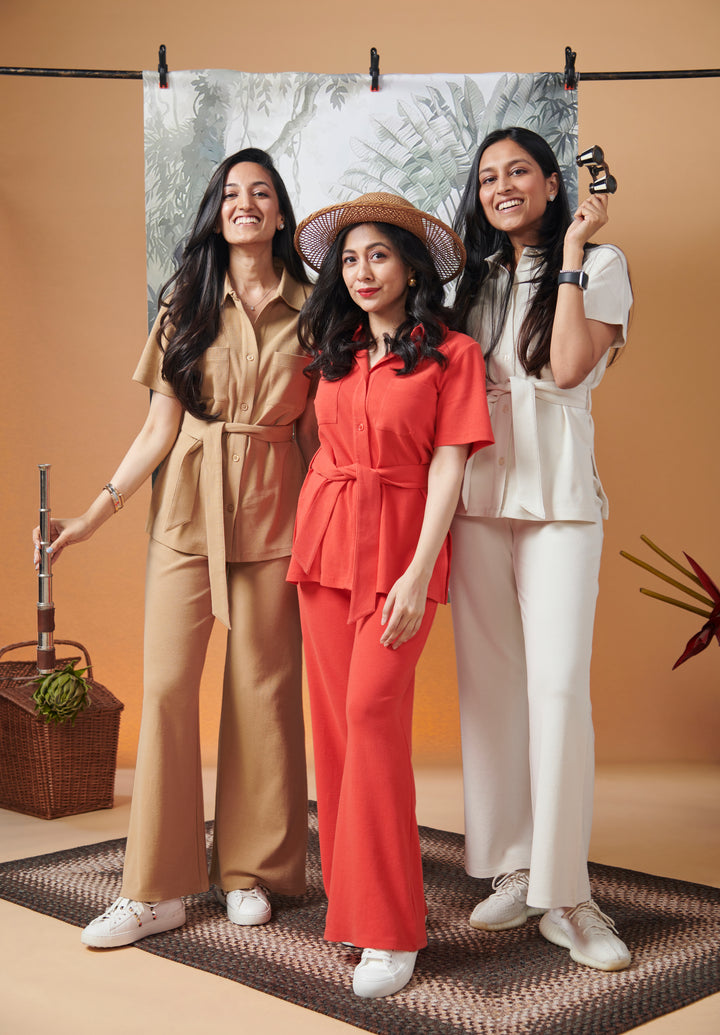 Women wearing stylish flared pants and tops in vibrant colors.