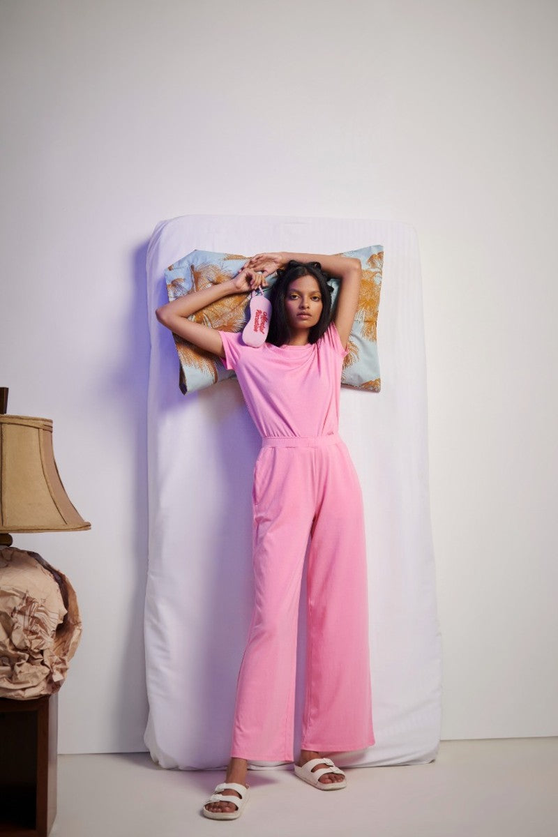 Model wearing stylish pink Supima® flared pants in modern setting.