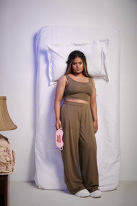 Olive Supima® set with crop top, cozy interior lifestyle image.