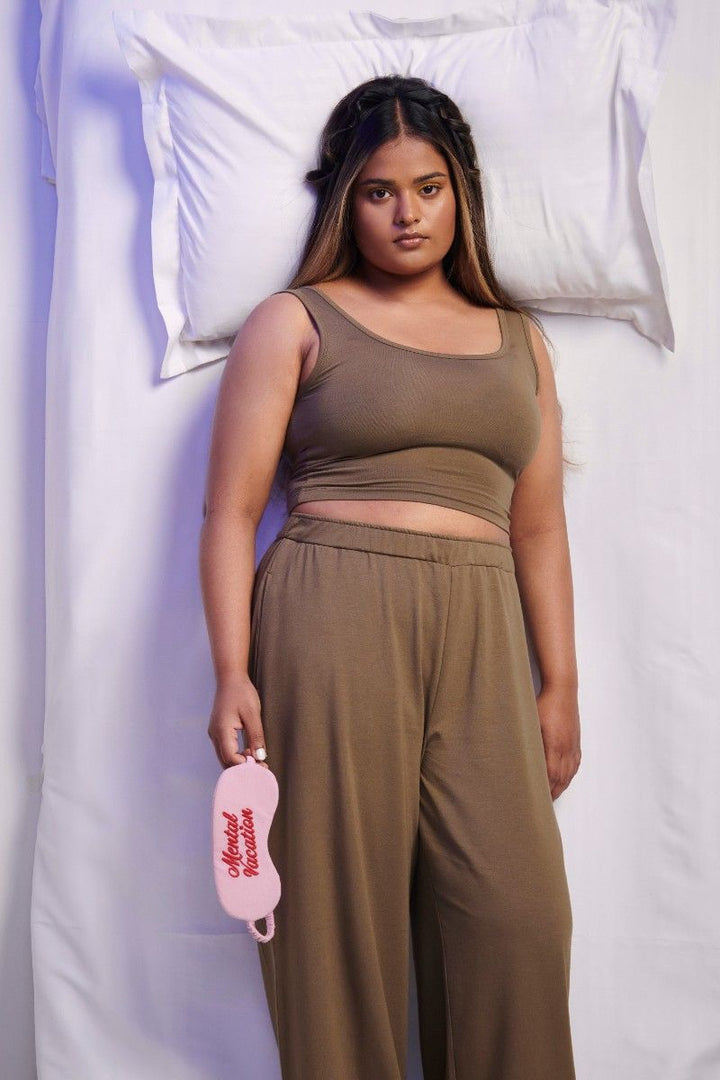 Olive Supima® crop top model lounging with sleep mask.