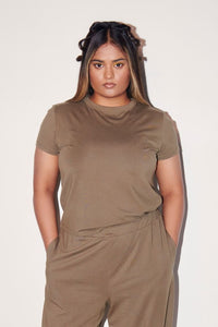 Olive Supima® T-Shirt displayed on a model in minimalist setting.