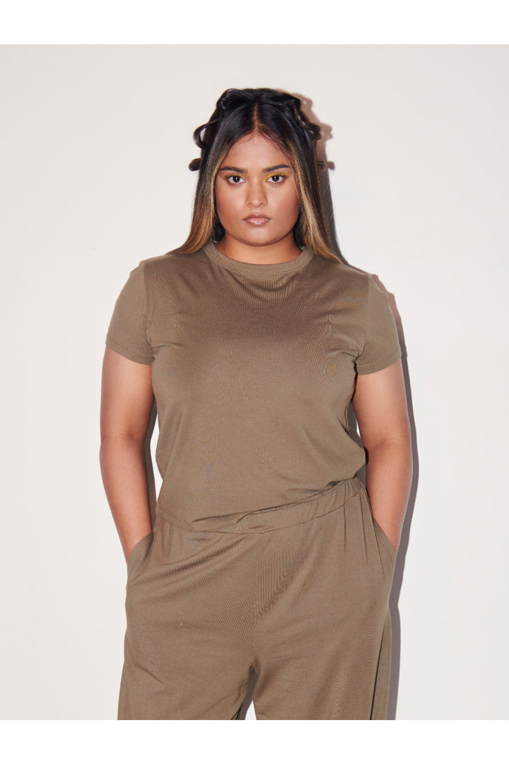 Olive Supima® T-Shirt styled with relaxed pants on model.