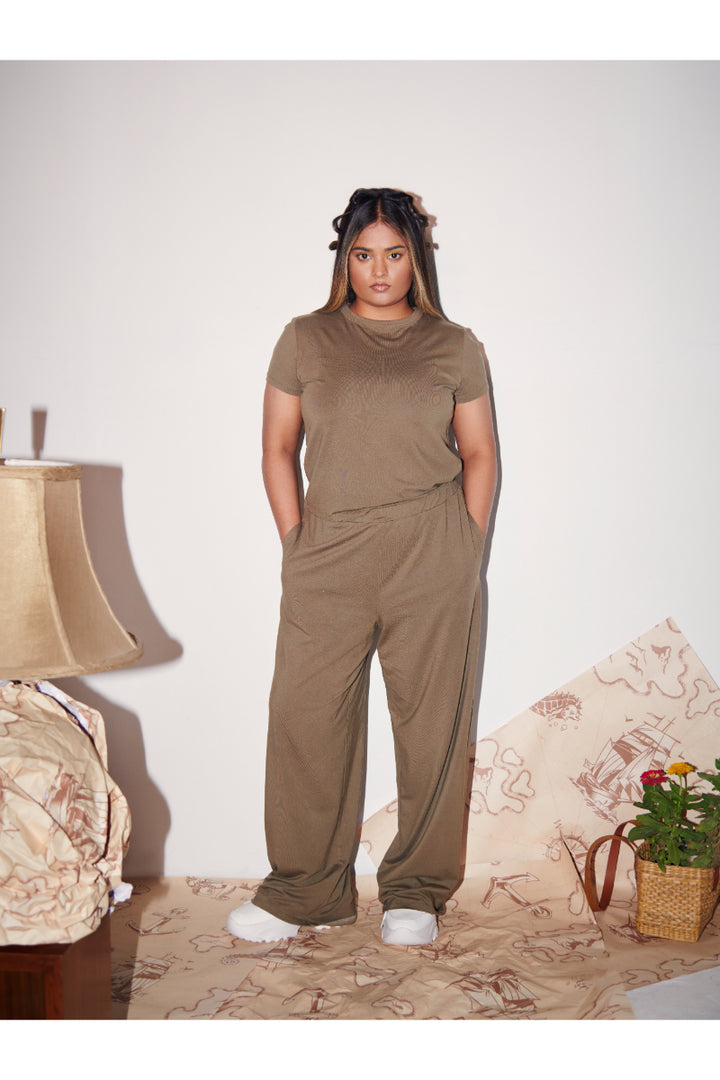 Olive Supima® T-Shirt styled with matching pants in a cozy setting.