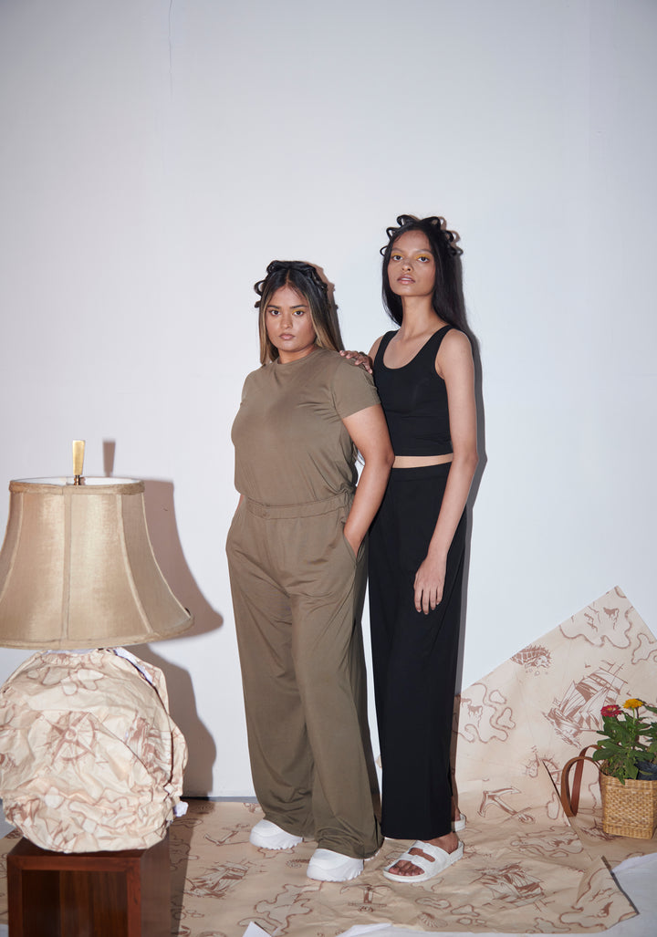 Olive Supima® flared pants styled with casual outfits in a trendy setting.
