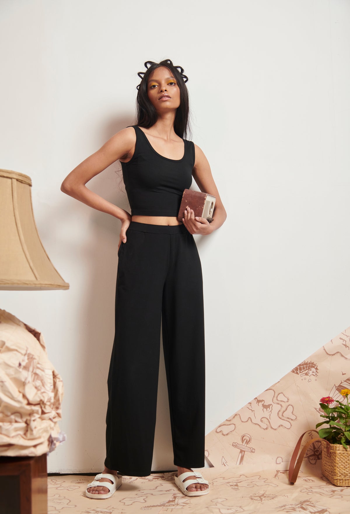 Model wearing Black Supima® Flared Pants against a minimalist backdrop.