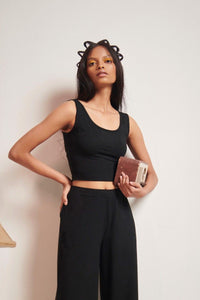 Black Supima® crop top styled with wide-leg pants and accessories.