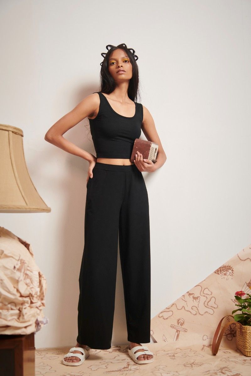 Black Supima® flared pants styled with a cropped top and accessories.