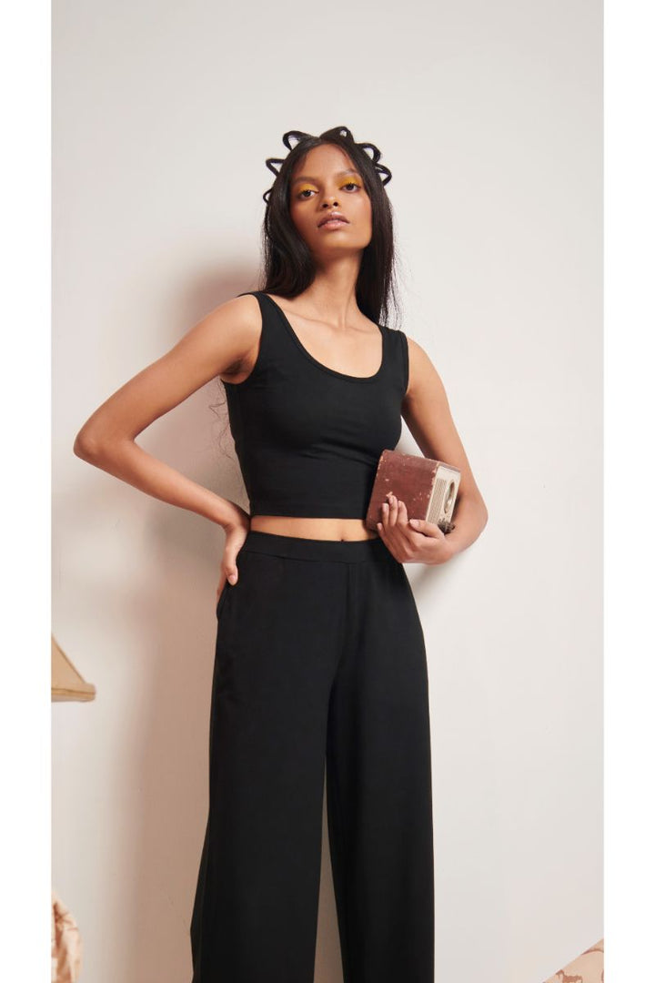 Black Supima® crop top paired with stylish black wide-leg pants.