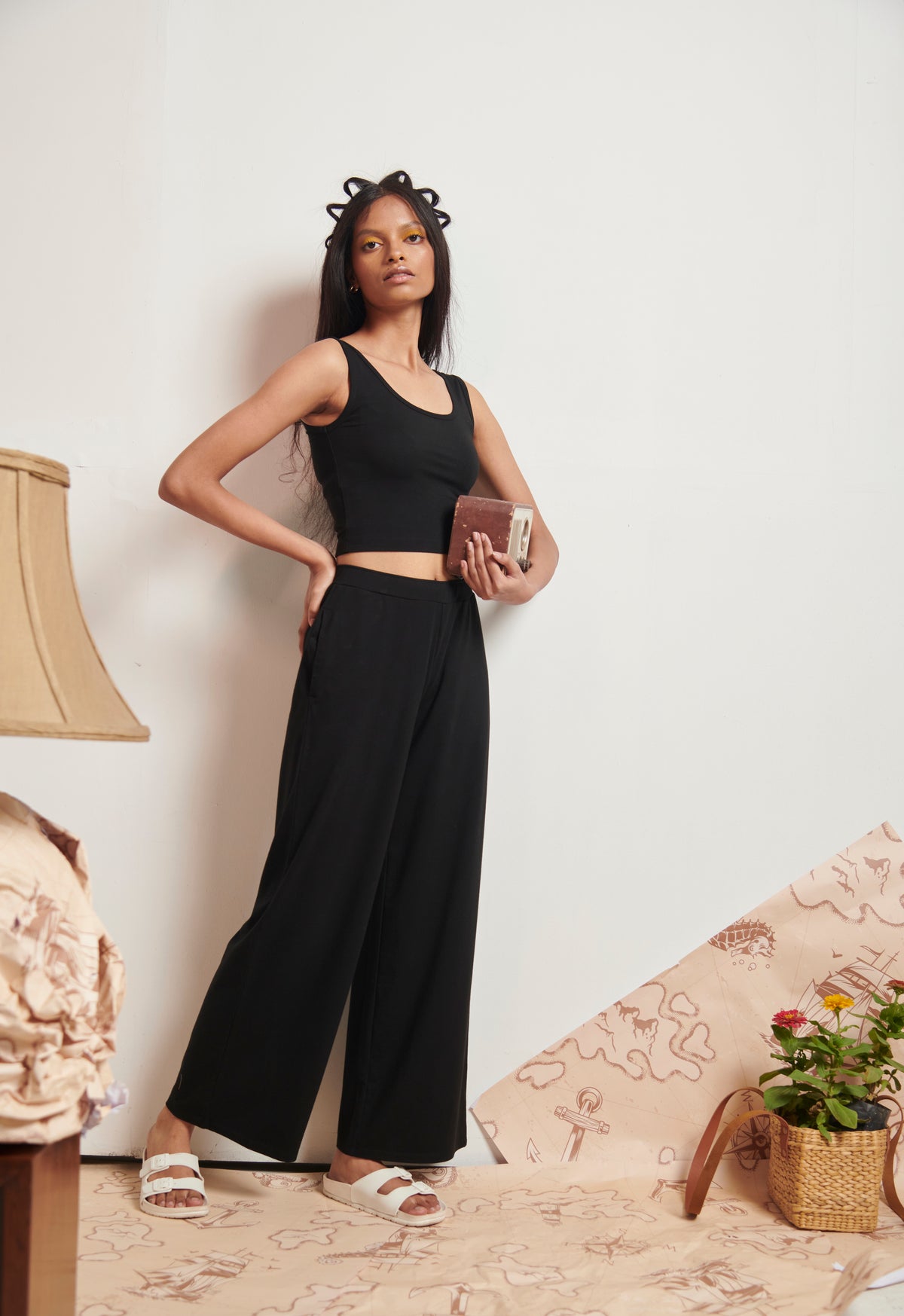 Model showcasing stylish Black Supima® Flared Pants with crop top.
