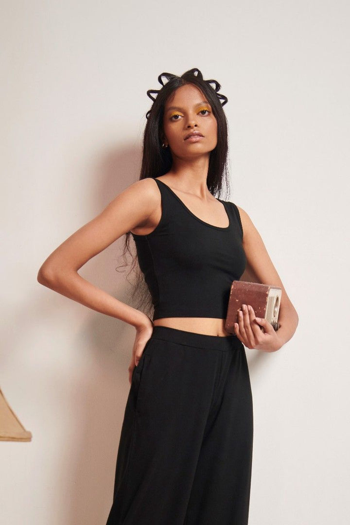Black Supima® crop top showcased with stylish accessorizing.