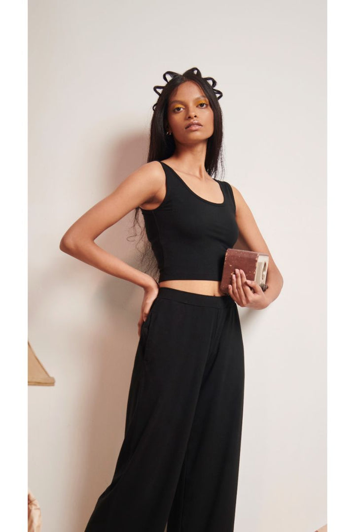 Black Supima® crop top styled with wide-leg pants.