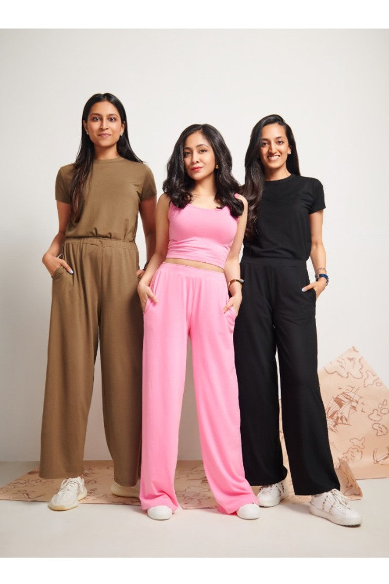 Pink Supima® crop top displayed with stylish outfits on three models.