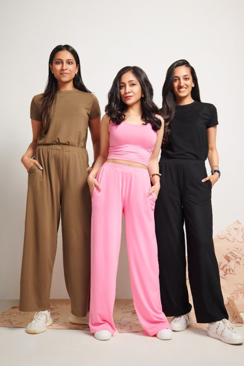 Three women modeling stylish loungewear, featuring a pink Supima® crop top.