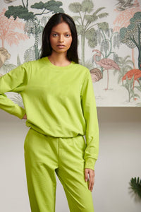 Bamboo Terry Green Travel Jogger Set model wearing bright green outfit.