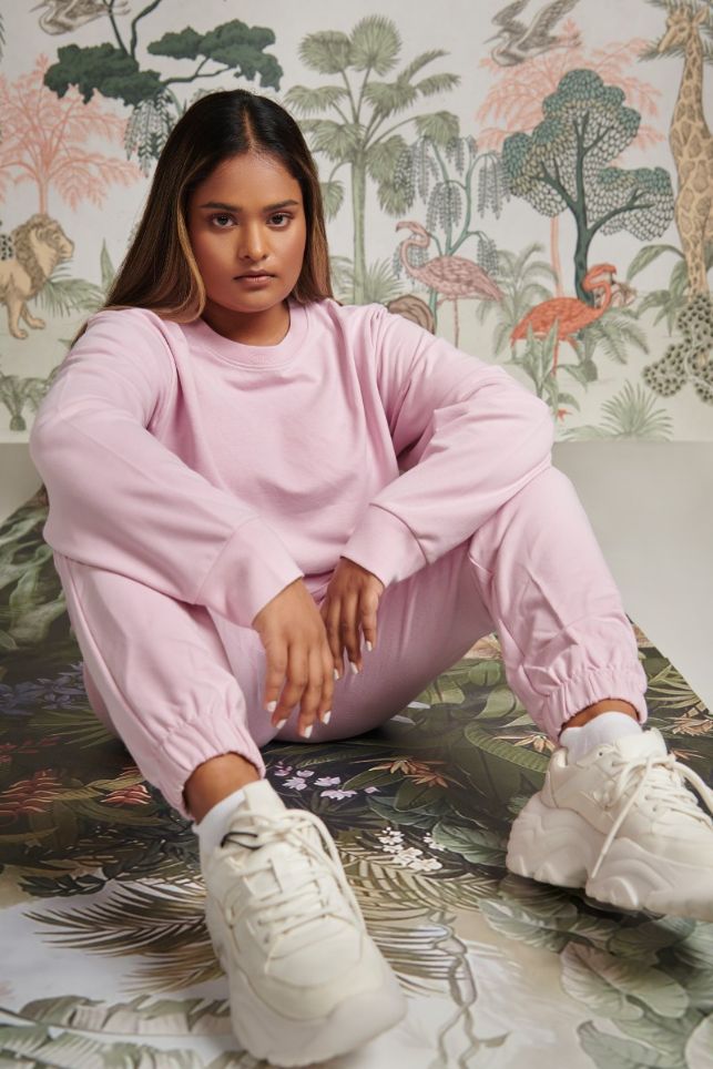 Model wearing a pink bamboo terry sweatshirt and matching pants.