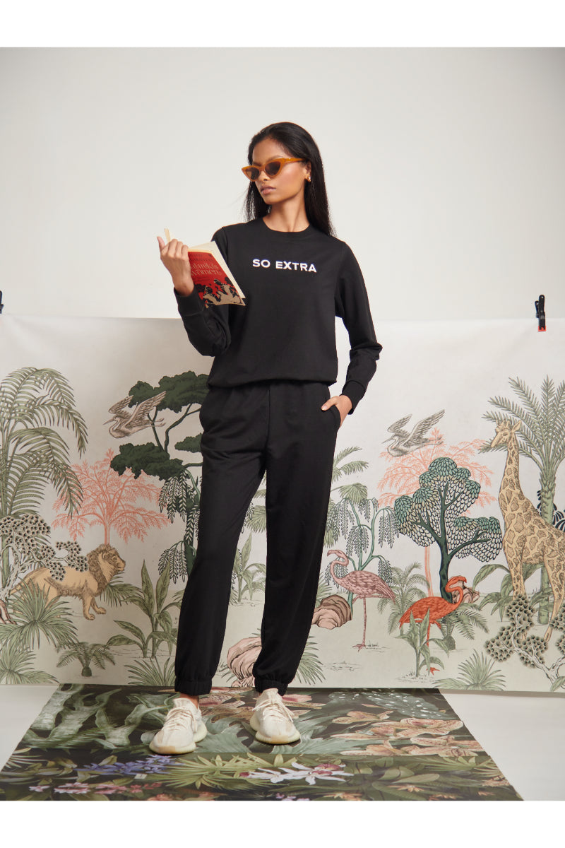 Model wearing black "So Extra" bamboo terry sweatshirt and pants.