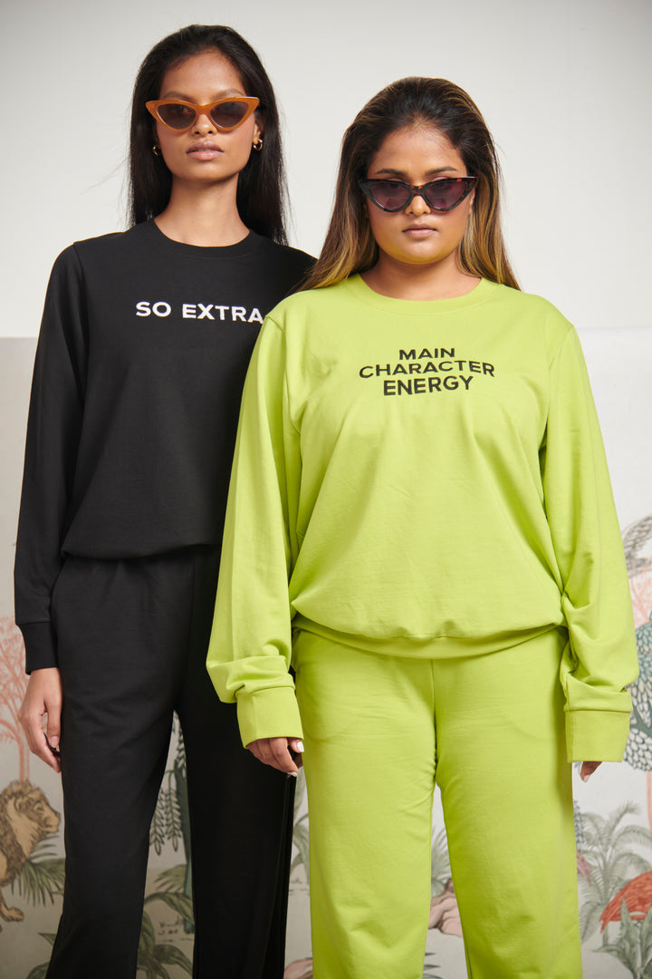 Models wearing So Extra Bamboo Terry Sweatshirts in black and neon green.