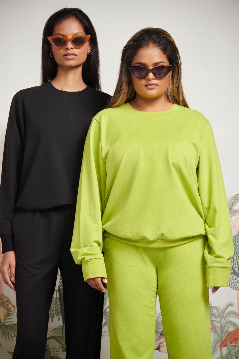 Green Bamboo Terry Sweatshirt showcased by two models in stylish sunglasses.