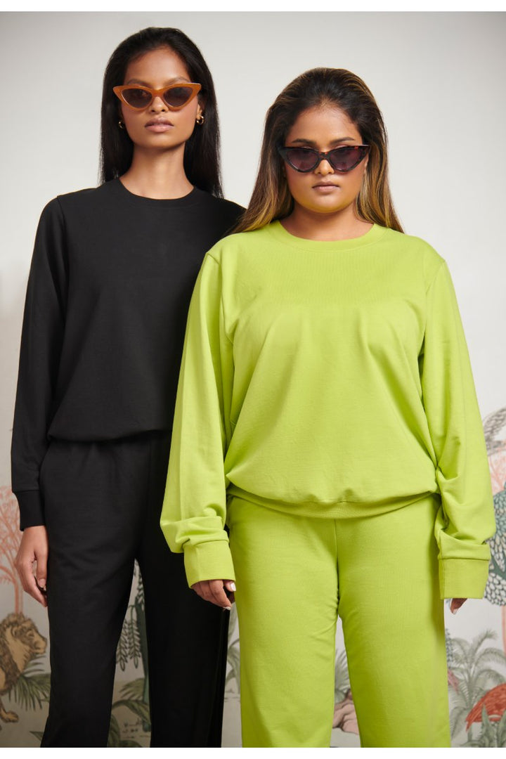 Green Bamboo Terry Sweatshirt styled with black and green outfits.