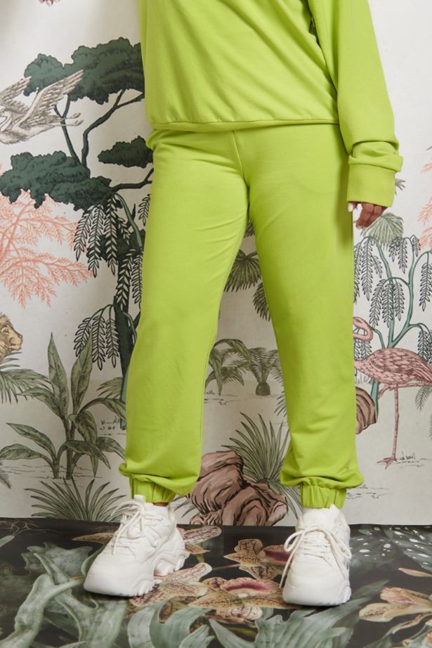 Bamboo Terry Green Travel Joggers with stylish white sneakers.
