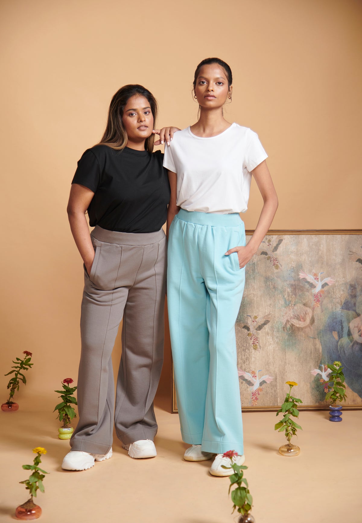 Blue Terry High Waist Travel Pant styled with casual tops and plants.