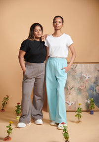 Two women modeling a blue terry travel set with relaxed styles.