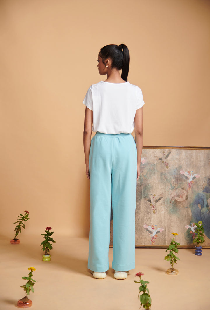 Blue Terry High Waist Travel Pant worn by model, styled against a pastel background.