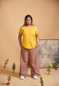 Brown terry travel set featuring a vibrant yellow top and relaxed pants.