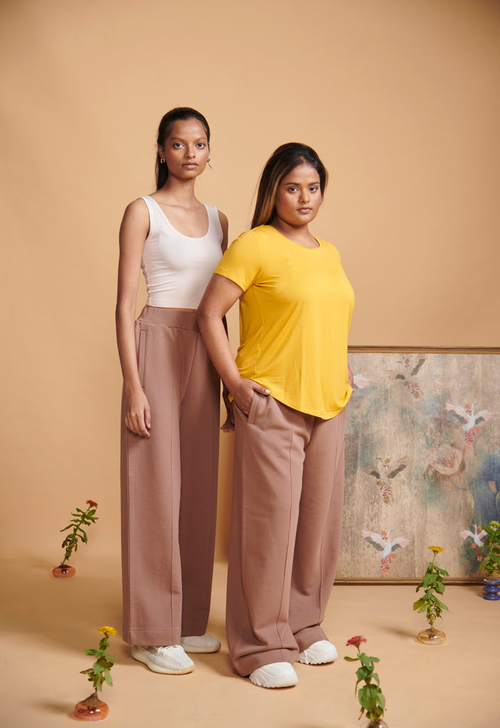 Brown terry high waist travel pant styled with casual tops.