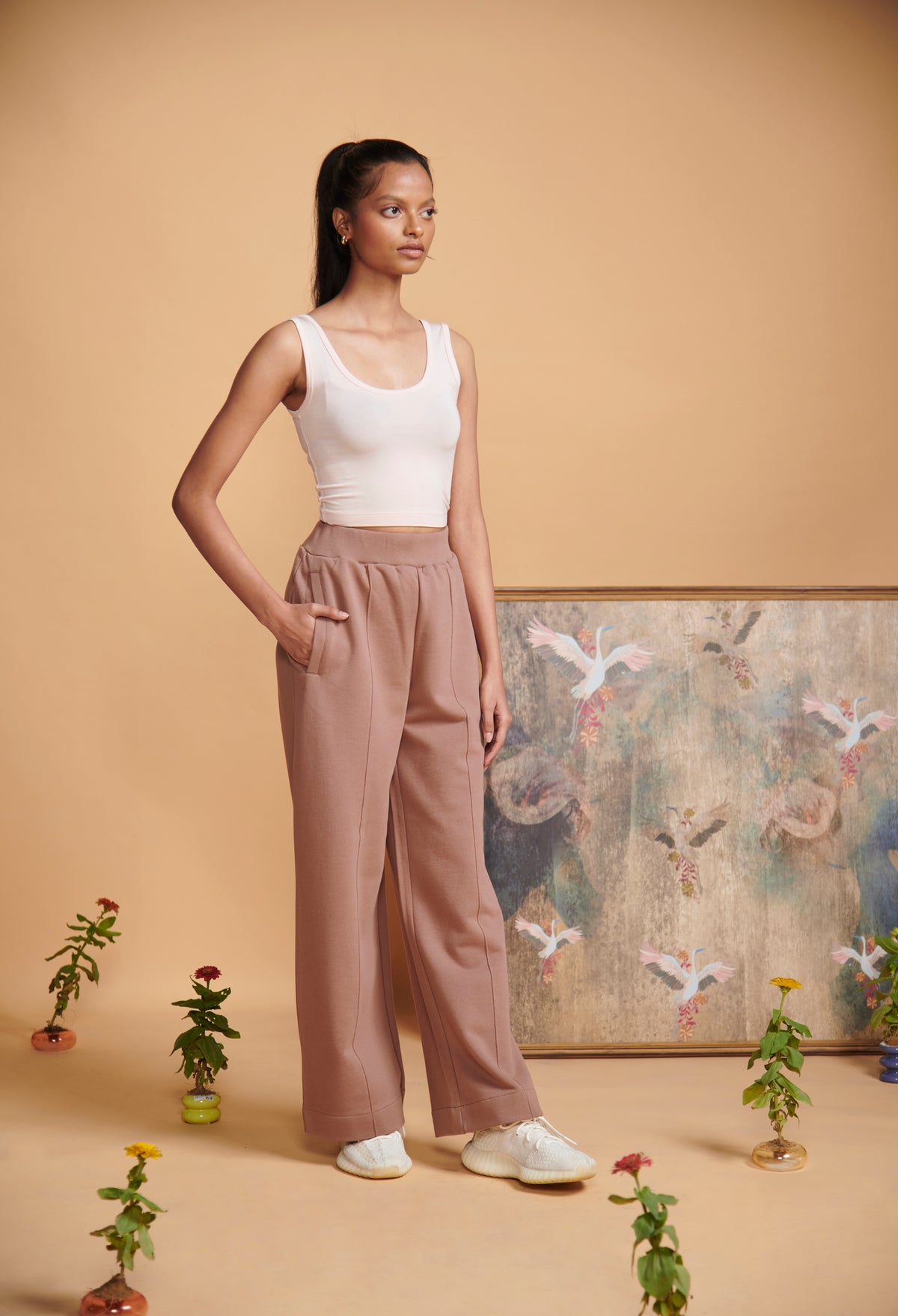 Brown terry high waist travel pant styled with a white tank top.