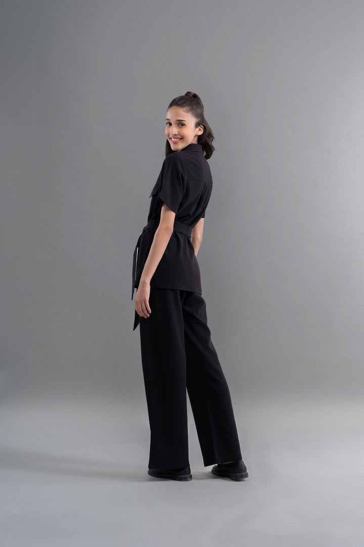 Model wearing Safari Lushknit® 2.0 Black Shirt with stylish pants.