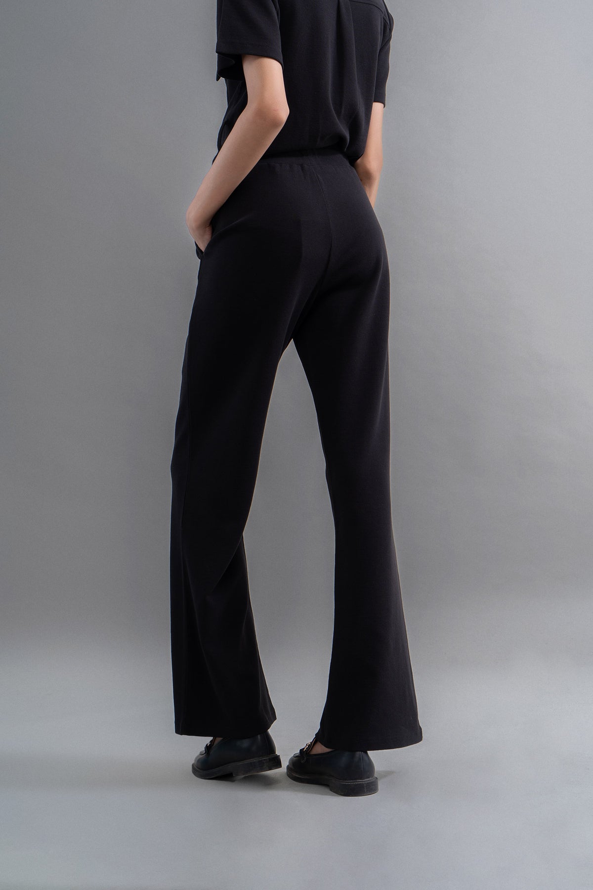 Lushknit® 2.0 black straight multitask pants worn from the back.