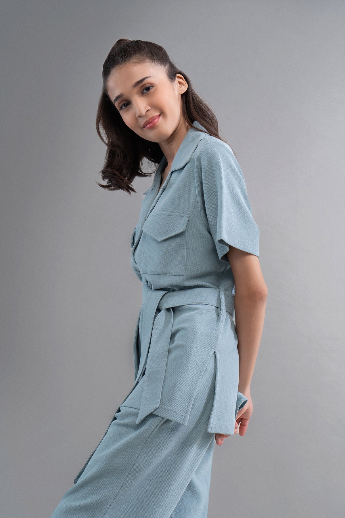Woman in Aqua Safari Lushknit® 2.0 Shirt posing stylishly.