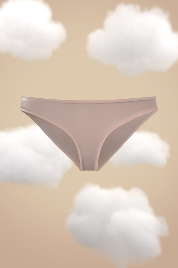 Supima Modal Bikini Nessies in soft pink against a cloud background.