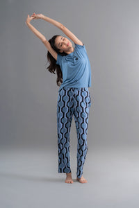 Midnight blue geometric heart pajama set model stretching in studio.