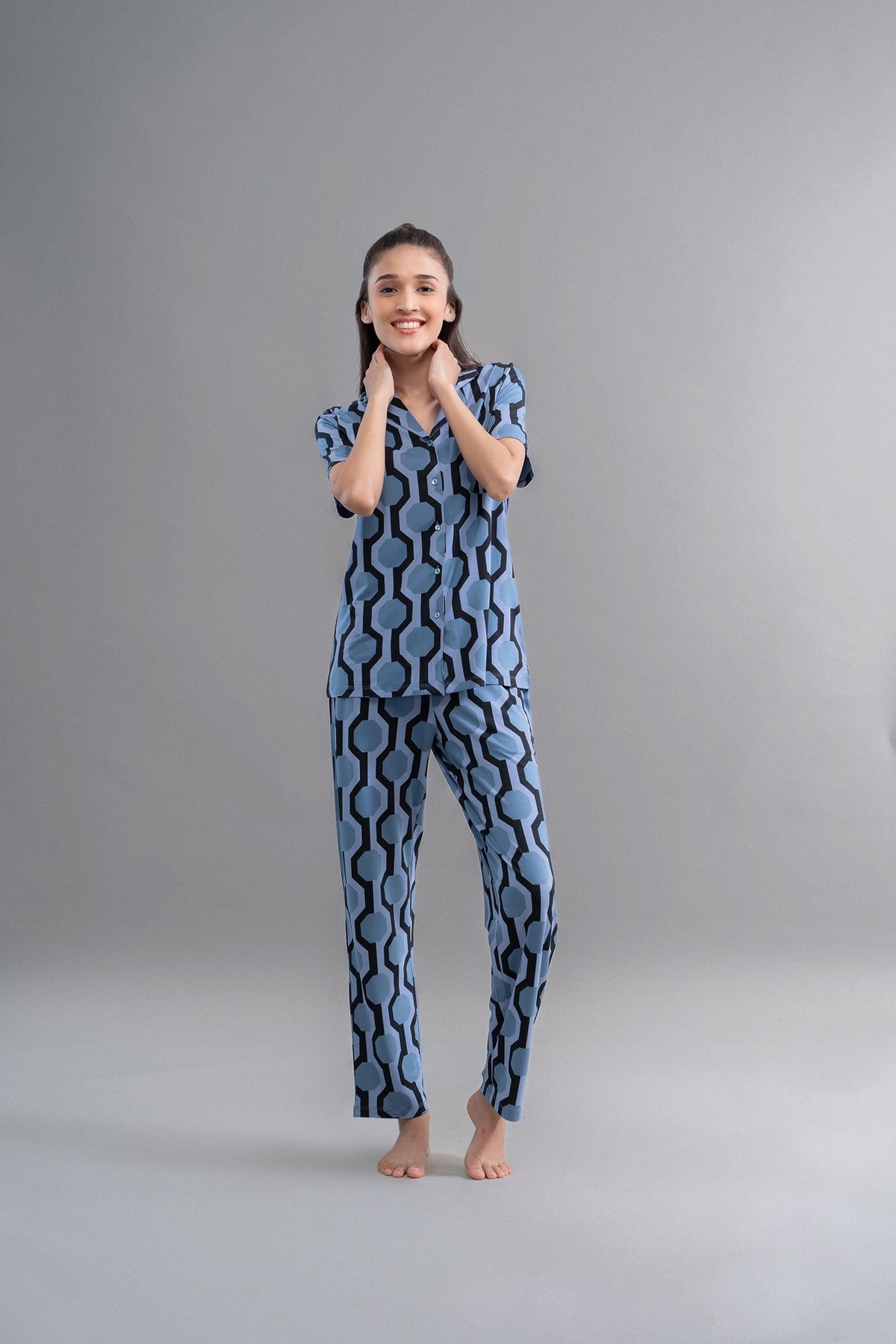 Midnight blue geometric modal button-down shirt modeled by smiling woman.