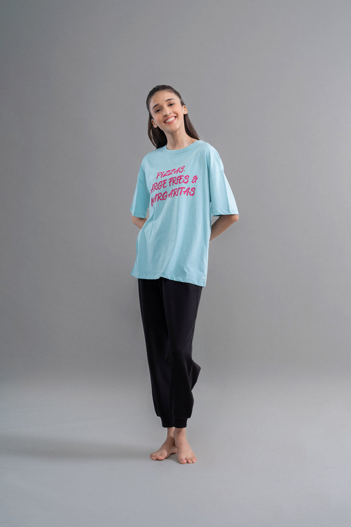 Stylish woman wearing Snugknit® black joggers with casual t-shirt.